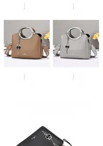 Detail view of large capacity pebbled leather handbag with metal ring handle and heart charm