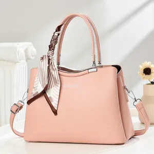 Pink lychee grain leather handbag with silk scarf and adjustable shoulder strap