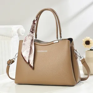 Brown litchi grain leather handbag with Fashion & Bag text and striped silk scarf