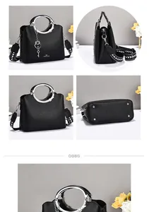 Detail of black pebbled leather tote with geometric strap and silver ring handle