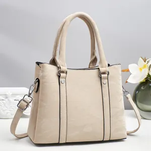 Chic beige textured faux leather tote bag with silver hardware and adjustable strap