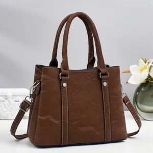 Dark brown textured tote bag with white stitching and silver hardware for women