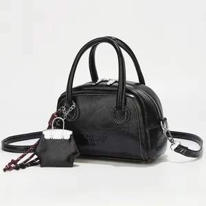 Chic black vintage oil leather square bag with star charm and silver hardware accents