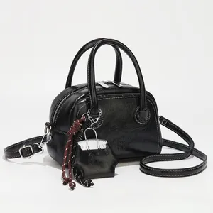 Chic black vintage oil leather square Boston bag with crossbody strap and woven charm