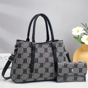 Detail of the jacquard B-pattern tote bag and matching long wallet with silver hardware