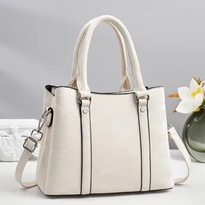 Detail view of cream handbag showing marbled synthetic leather and silver metal buckles