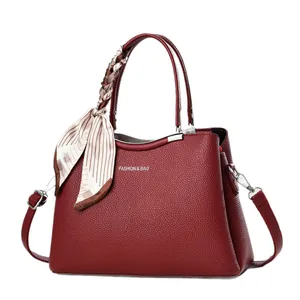 Deep burgundy leather tote bag with lychee texture and decorative silk scarf detail