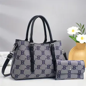 Detail of grey monogram tote bag set with matching long wallet and silver hardware