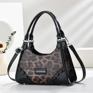 Fashion leopard print handbag with black patent leather trim and a crossbody strap