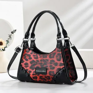 Fashionable red leopard print patent leather handbag with rivets and cross-body strap