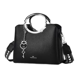 Fashionable black pebbled leather tote bag with silver ring handles and patterned strap