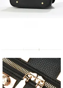 Détail d'un sac à main en cuir grainé noir avec rivets dorés au fond et zips métalliques