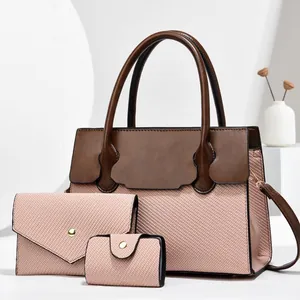 Detailed view of 3-piece woven textured handbag set with dark brown leather handles