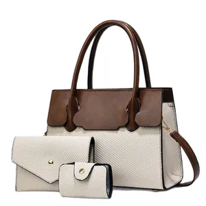 Three-piece women's handbag set featuring canvas tote, wallet, and card holder in brown