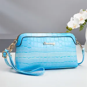 Fashionable light blue shell bag with crocodile pattern and adjustable shoulder strap