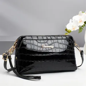 Black glossy crocodile pattern shell shoulder bag with golden Danbaoly logo and strap