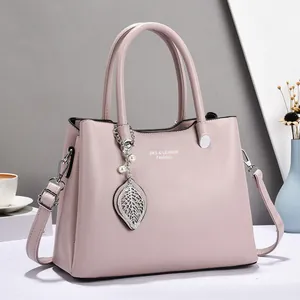 Elegant mauve leather handbag for women with pearl leaf pendant and shoulder strap