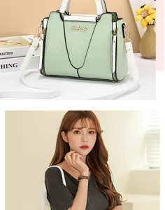Detail of mint green and white PU leather handbag with litchi texture and metal logo