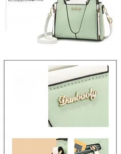 Detail of mint green handbag featuring white contrast handles and gold Danbaoly logo