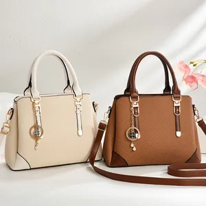 Women's woven shoulder bags in beige and brown with clover charm and adjustable strap