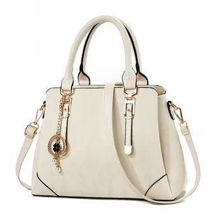 Elegant cream white glossy faux leather handbag with gold hardware and chain charm