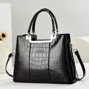 Elegant black crocodile pattern handbag with silver metal handles and adjustable strap