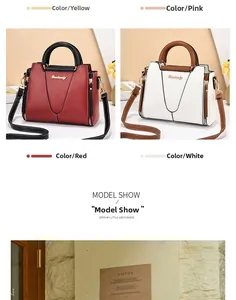 Detail view of stylish PU leather handbag with gold logo, top handles and shoulder strap
