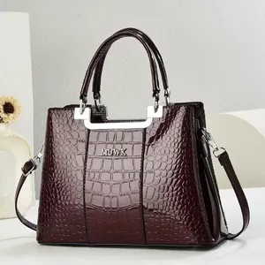 Elegant burgundy crocodile pattern handbag with silver hardware and shoulder strap