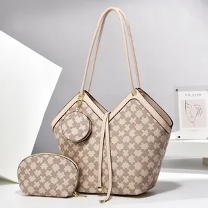 Detailed set view of a tote bag with matching cosmetic pouch and round charm pendant