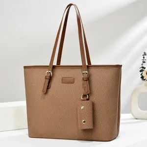 Brown woven tote bag with adjustable strap and coin purse against a minimalist white background