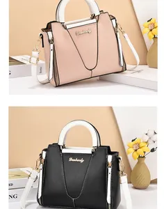 Detail of color-block tote bags in pink and black with golden logo and chain strap