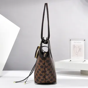 Detail view of large checkerboard tote bag with brown puzzle pattern and mini coin purse