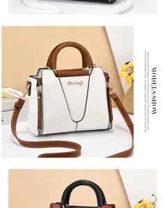 Detail showing contrast stitching and metal logo on white and brown leather handbag
