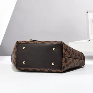 Checkerboard pattern tote bag with premium leather base and protective metal studs