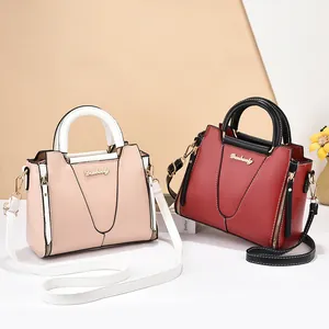 Fashionable contrast color leather handbags with gold hardware and top handles
