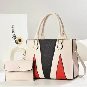 Detailed view of color-block tote bag set with lychee texture and gold-tone hardware