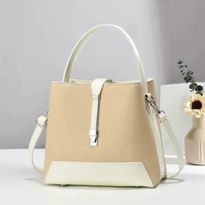 Women's chic beige woven and cream leather trapezoid handbag with silver buckle