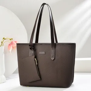 Close-up of deep brown tote bag with woven texture and matching zipper pouch
