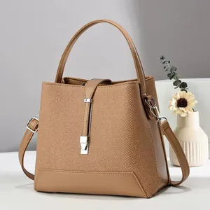 Chic brown woven texture bucket bag with leather strap and silver buckle detail