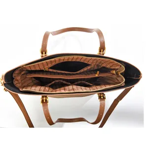 Interior detail of a brown tote bag showing multiple compartments and striped lining