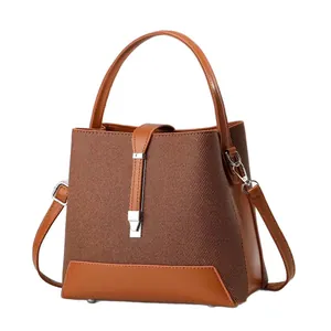 Brown woven fabric and leather satchel with top handle and adjustable shoulder strap