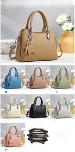 Detailed view of women's tote bag size 26.5x11.5x20cm with star pendant and inner layers