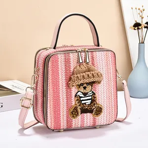 Pink striped woven handbag featuring a cute bear patch and leather shoulder strap
