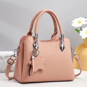Pink lychee texture faux leather tote bag with top handles and adjustable strap
