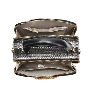 Top view of woven crossbody bag showing dual zipper compartments and black leather handles