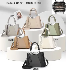 Detailed view of the 25cm crossbody bag's 3-compartment interior and metal handle