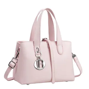 Elegant pink leather handbag for women featuring a top handle and removable shoulder strap