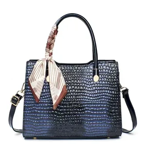 Blue-black gradient tote bag with crocodile texture, silk scarf handle, and gold hardware