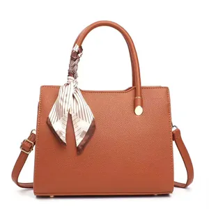 Brown litchi grain handbag featuring a decorative striped silk scarf and gold hardware