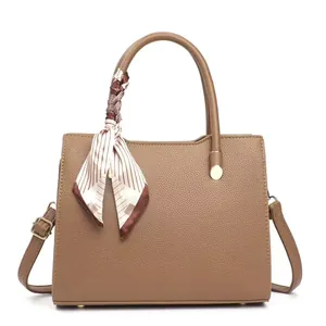 Deep camel lychee pattern leather handbag with striped silk scarf on white background